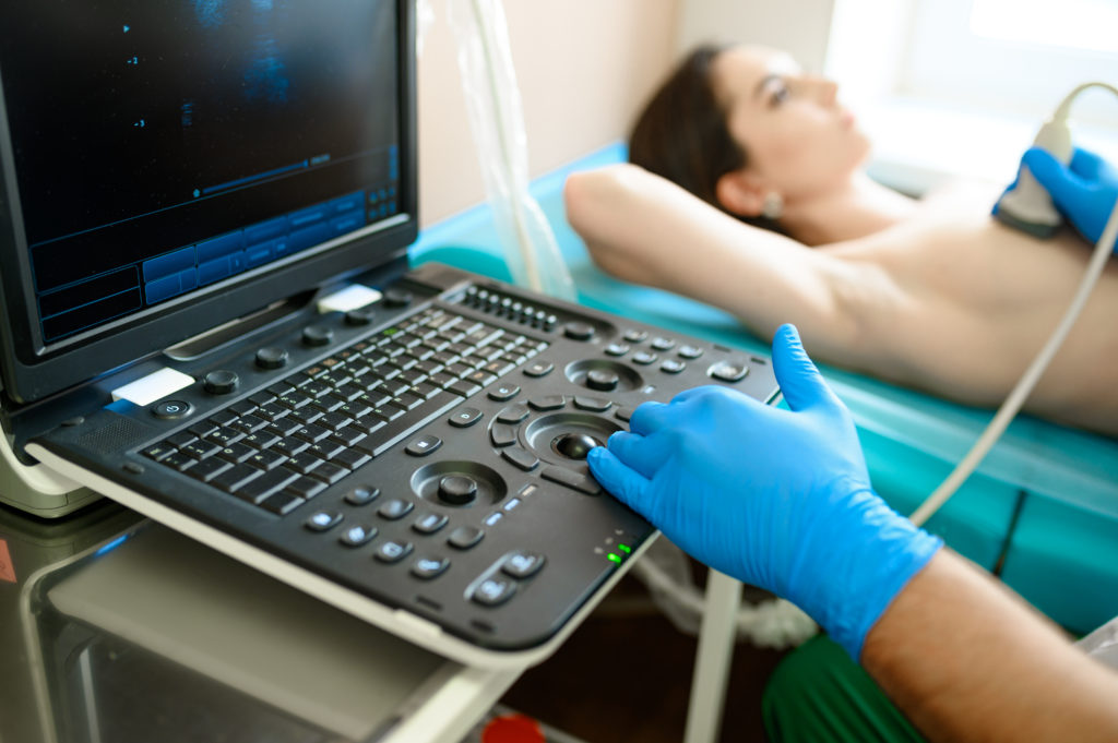 mammologist performs breast ultrasound scanning